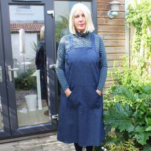 Fiona outside her garden studio, while wearing the Mildred pinafore